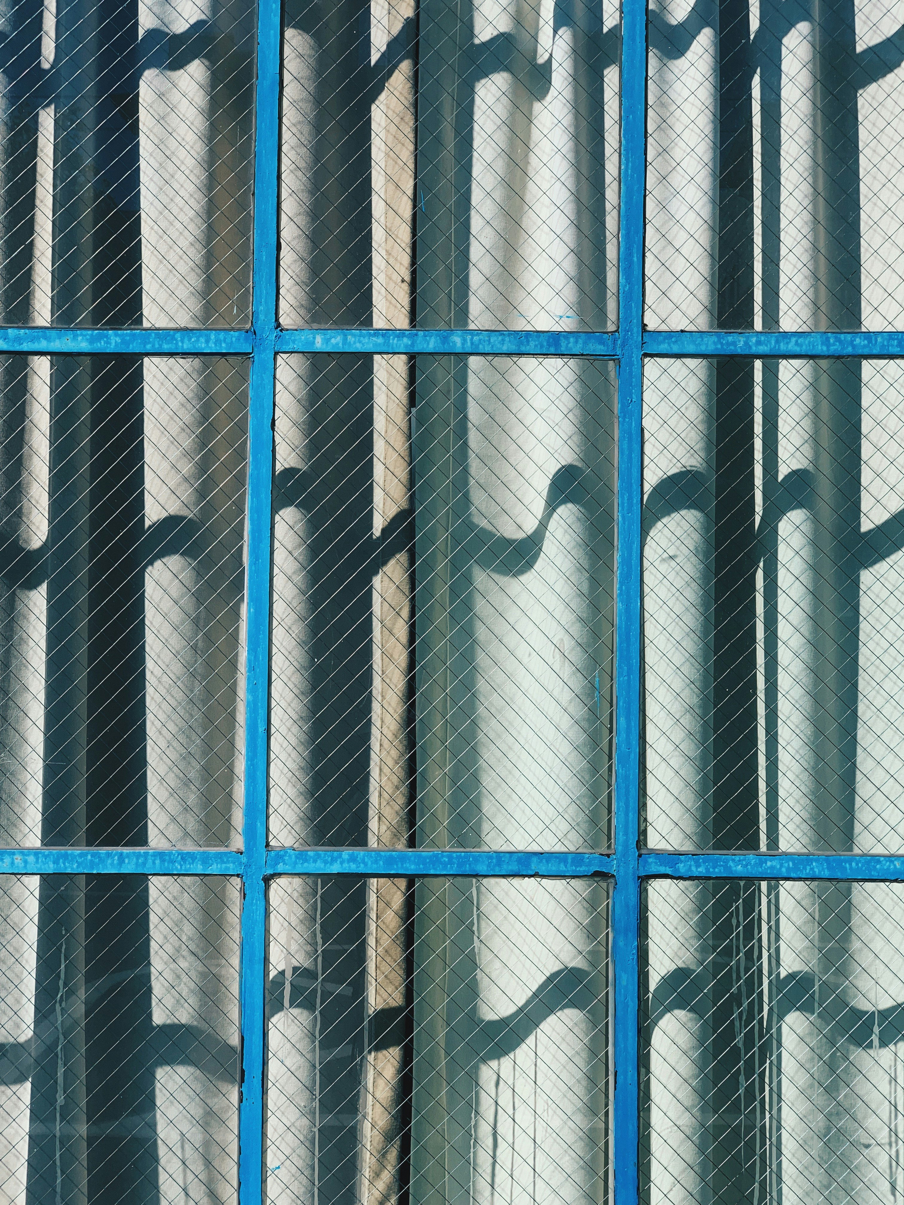 gray curtain and brown framed clear glass window during daytime